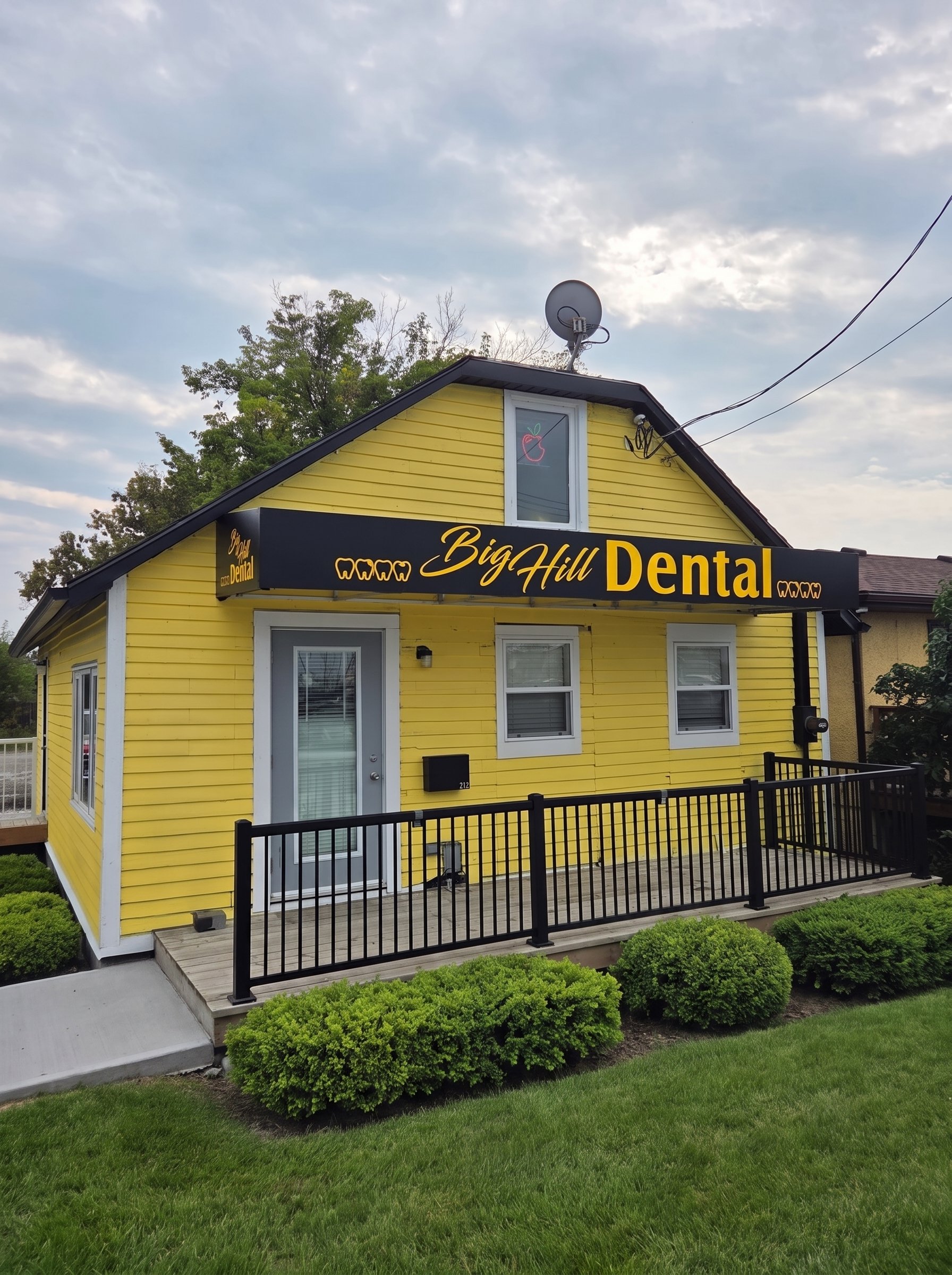 Big Hill Dental's yellow heritage house on 3rd Avenue West in Cochrane, Alberta